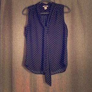 Navy and white sleeveless polka dot blouse